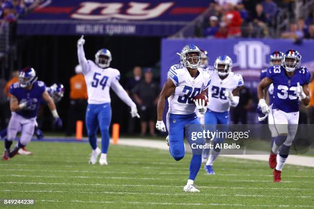 Jamal Agnew of the Detroit Lions returns an 88 yard punt return for a touchdown in the fourth quarter against the New York Giants during their game...