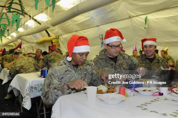 Lance Corporal Carlos Da Costa from Jamaica, Corporal Al Butterfill from Doncaster and SAC Curtis Shield from Blackpool enjoy Christmas dinner in...