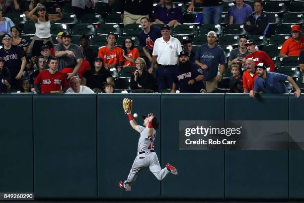 Left fielder Andrew Benintendi of the Boston Red Sox misses a RBI double hit by Austin Hays of the Baltimore Orioles in the fifth inning at Oriole...