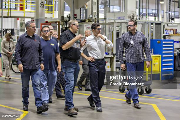 House Speaker Paul Ryan, a Republican from Wisconsin, front second right, talks with company representatives as Matthew "Matt" Levatich, chief...