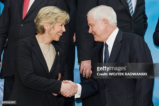 Norway's Defence Minister Anne-Grete Strom-Erichsen shakes hands with U.S. Secretary for Defense Robert Gates before a family photo during the NATO...