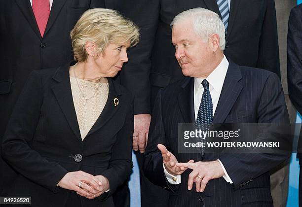 Norway's Defence Minister Anne-Grete Strom-Erichsen chats with U.S. Secretary for Defense Robert Gates before a family photo during the NATO Defence...