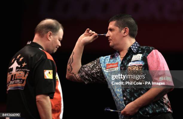 Gary Anderson in action against Raymond van Barneveld during the Third Round of the Ladbrokes.com World Darts Championship at Alexandra Palace,...