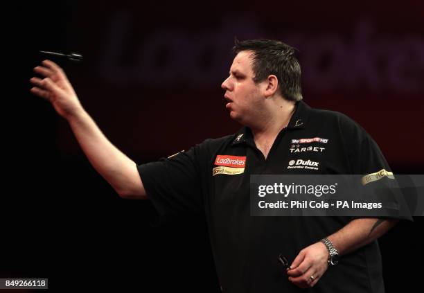 Adrian Lewis in action against Kevin Painter of the Ladbrokes.com World Darts Championship at Alexandra Palace, London.