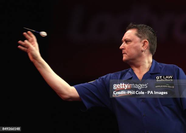 Kevin Painter in action against Adrian Lewis during the Third Round of the Ladbrokes.com World Darts Championship at Alexandra Palace, London.