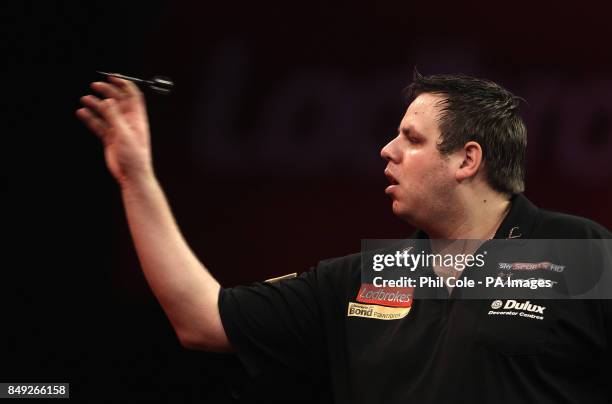 Adrian Lewis in action against Kevin Painter of the Ladbrokes.com World Darts Championship at Alexandra Palace, London.