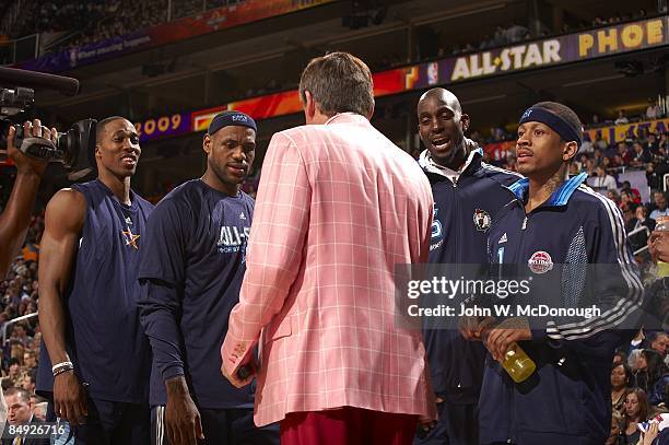 All-Star Game: Team East Dwight Howard , LeBron James , Kevin Garnett , and Allen Iverson looking at pink blazer and red slacks of TNT announcer...