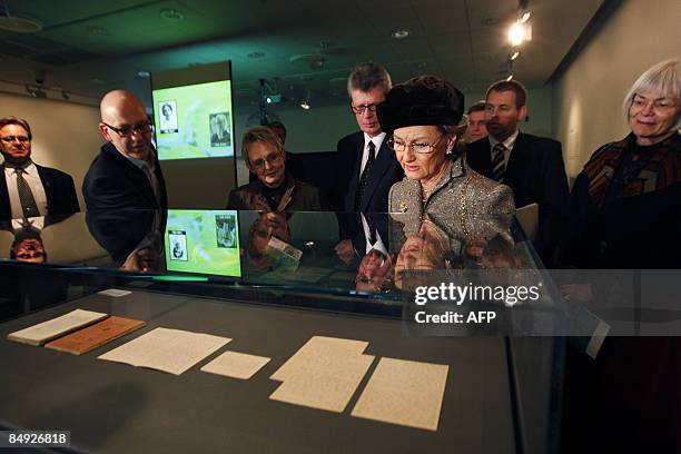 Norwegian Queen Sonja looks at part of the original manuscript of Knut Hamsuns novel "Sult" -Hunger-, published in 1890 as she attends the...