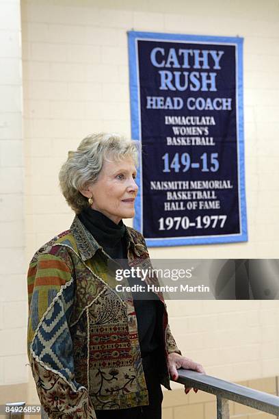 Cathy Rush stands in front of a banner honoring her career as head coach of women's basketball from 1970 to 1977 at Immaculata University in...
