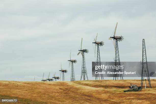 wind turbines on the roadside with one of them broken by the wind, california, united states - central valley california stock pictures, royalty-free photos & images