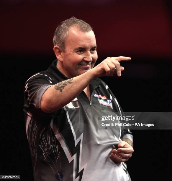 Phil Taylor on his way to beating Andy Hamilton during the Ladbrokes.com World Darts Championship at Alexandra Palace, London.