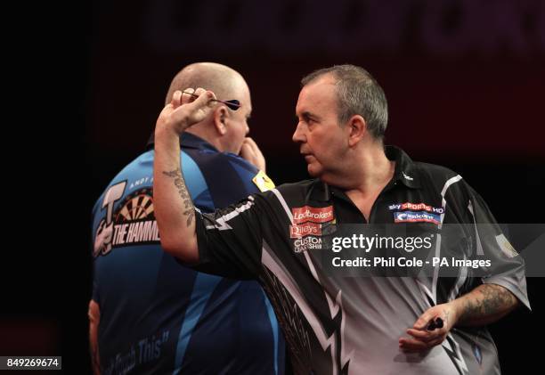 Phil Taylor in action against Andy Hamilton during the Ladbrokes.com World Darts Championship at Alexandra Palace, London.