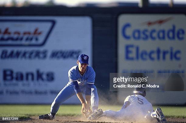 Minor League Baseball: Medicine Hat Blue Jays Mike Coolbaugh in action, attempting tag vs Great Falls Dodgers. Great Falls, MT 6/1/1990--6/30/1990...