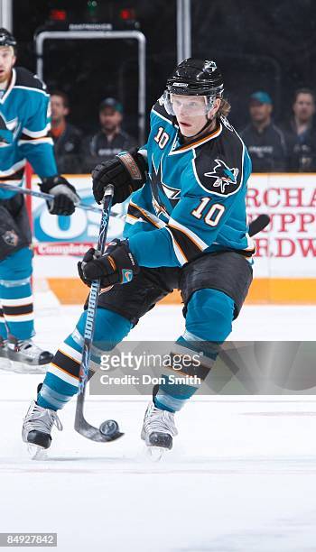 Christian Ehrhoff of the San Jose Sharks flips up the puck during an NHL game against the Edmonton Oilers on February 17, 2009 at HP Pavilion at San...