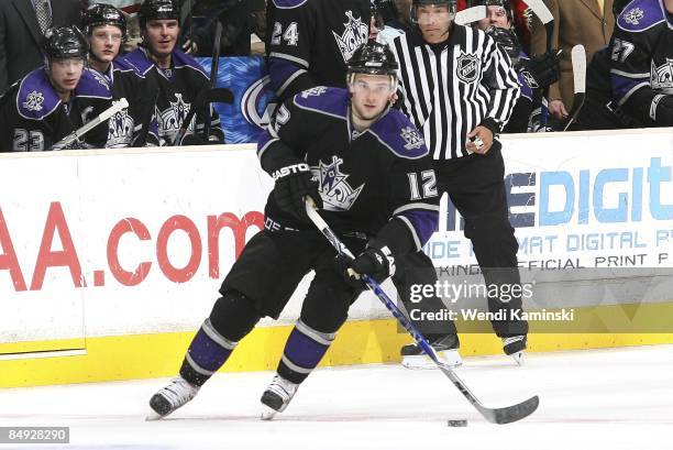 Patrick O'Sullivan of the Los Angeles Kings looks to pass the puck against the Calgary Flames on February 12, 2009 at Staples Center in Los Angeles,...