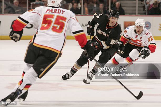 Jarome Iginla and Adam Pardy of the Calgary Flames defend against Scott Niedermayer of the Anaheim Ducks during the game on February 11, 2009 at...