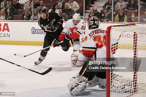 Miikka Kiprusoff of the Calgary Flames defends in the crease against the Anaheim Ducks during the game on February 11, 2009 at Honda Center in...