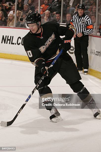 Corey Perry the Anaheim Ducks handles the puck behind the net against the Calgary Flames during the game on February 11, 2009 at Honda Center in...