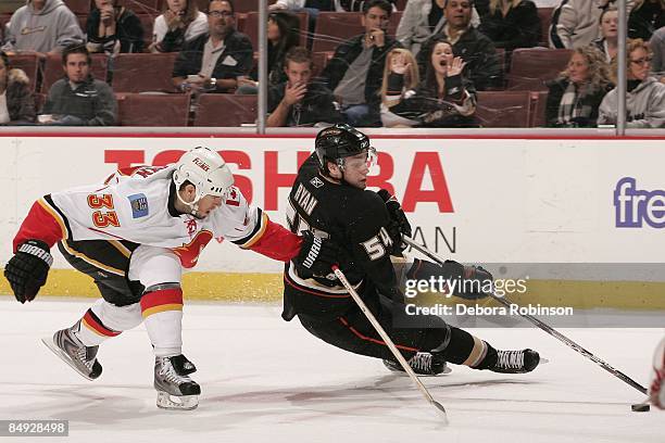 Bobby Ryan of the Calgary Flames controls the puck against Adrian Aucoin of the Anaheim Ducks during the game on February 11, 2009 at Honda Center in...