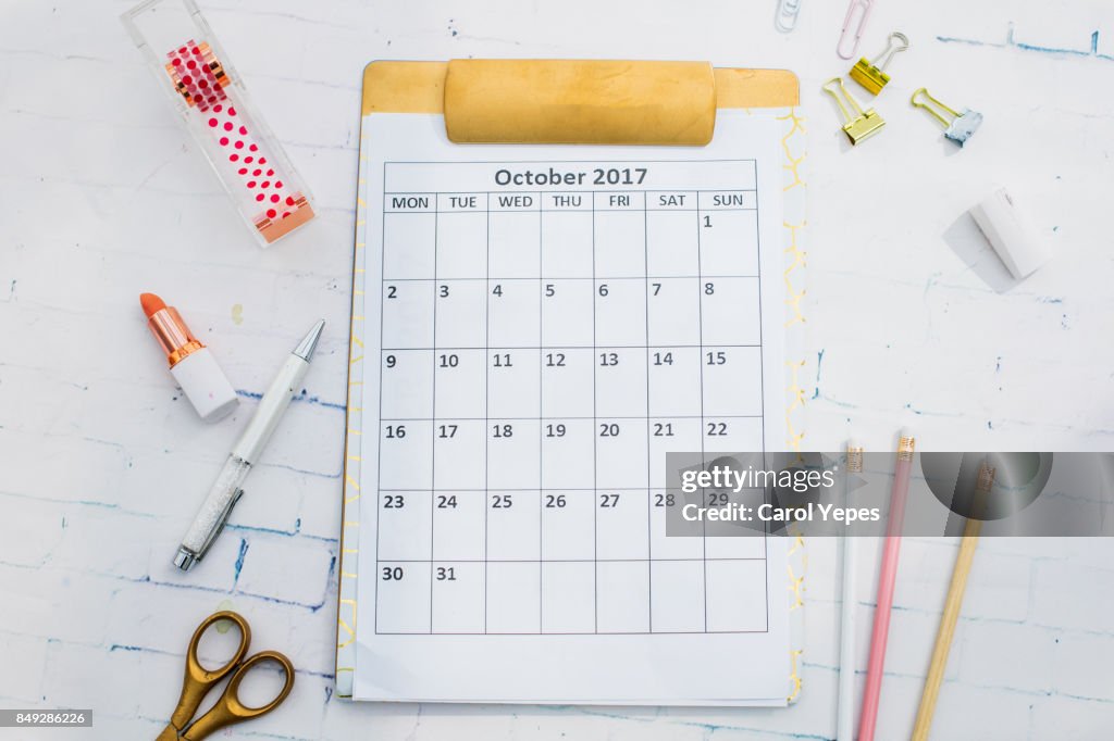 Flat lay desktop with october calendar