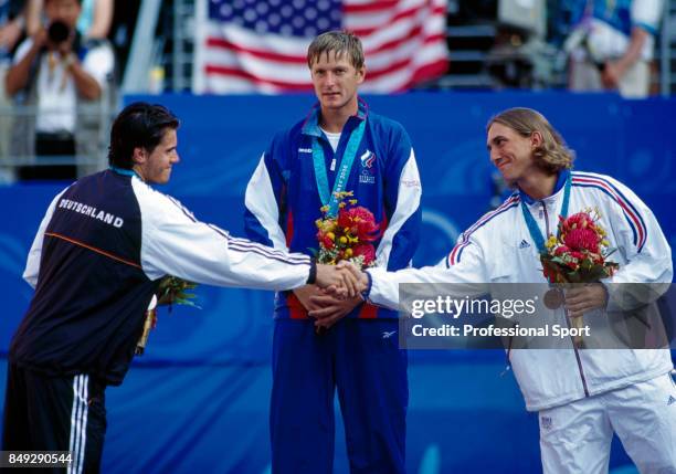 Tommy Haas of Germany , Yevgeny Kafelnikov of Russia and Arnaud Di Pasquale of France during the medal presentation ceremony for the men's singles...