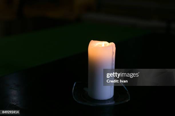 close-up of lit candle in darkroom - hatboro photos et images de collection