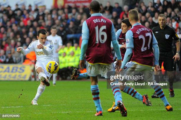 Swansea's Leon Britton has a shot on goal in the first half during the Barclays Premier League match at the Liberty Stadium, Swansea.