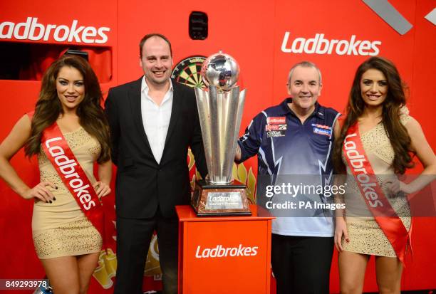 Phil Taylor and son of the late Sid Waddell, Dan with the trophy after Phil won the Ladbrokes.com World Darts Championship Final at Alexandra Palace,...