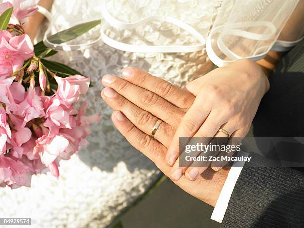 bride and groom hands with wedding rings - wedding ceremony alter stock pictures, royalty-free photos & images