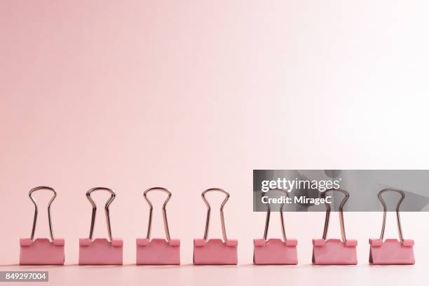 a row of binder clip - balance finance minimal stock pictures, royalty-free photos & images