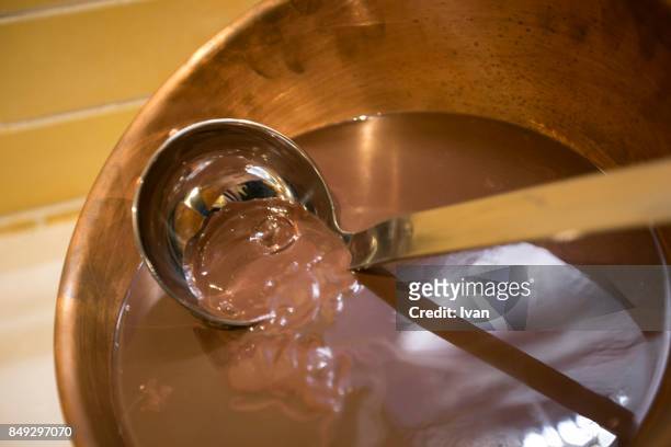 copper spoon and melting dark chocolate - switzerland chocolate stock pictures, royalty-free photos & images