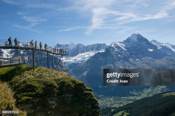 tourist in the first cliff walk with jungfraujoch mountain, switzerland - grindelwald stock pictures, royalty-free photos & images