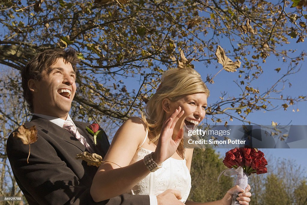 A wedding couple in an autumn wind