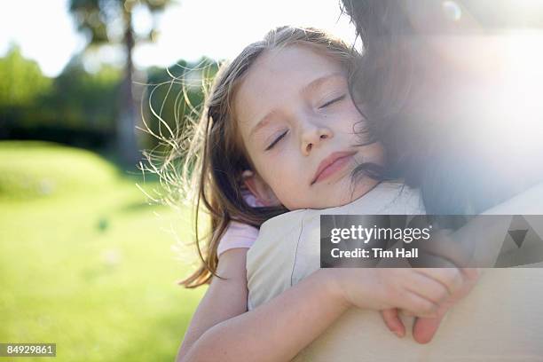 mother and daughter embracing - kid eyes closed stock pictures, royalty-free photos & images