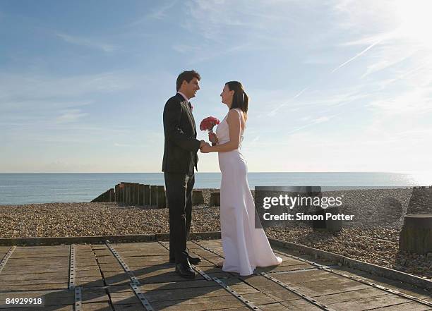 a wedding couple on the beach - wedding ceremony alter stock pictures, royalty-free photos & images