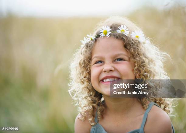 young girl laughing with daisies in hair - daisy chain stock pictures, royalty-free photos & images