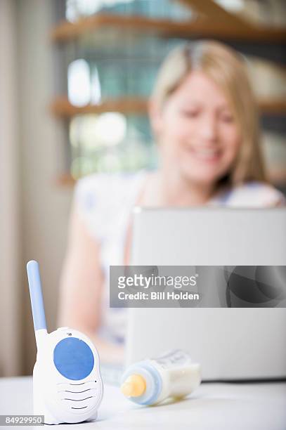a mother working from home - babyphone stock-fotos und bilder