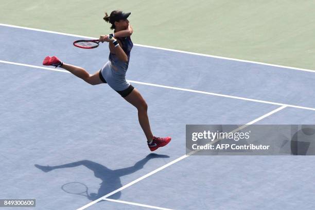 Caroline Garcia of France returns a shot to Aliaksandra Sasnovich of Belarus during their first round women's singles match in the Pan Pacific Open...