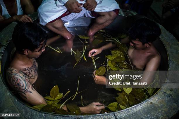 Recovering drug addicts sit in a boiling herbal bath administered by Ustad Ahmad Ischsan Maulana, the head of Nurul Ichsan Al Islami traditional...