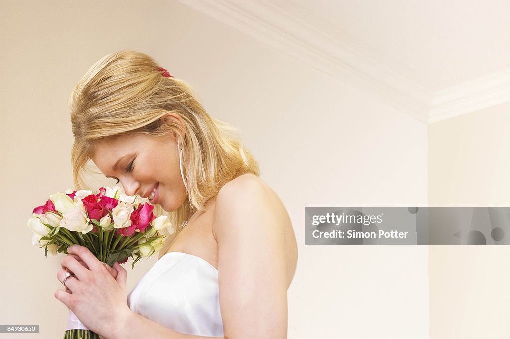 A bride smelling her bouquet