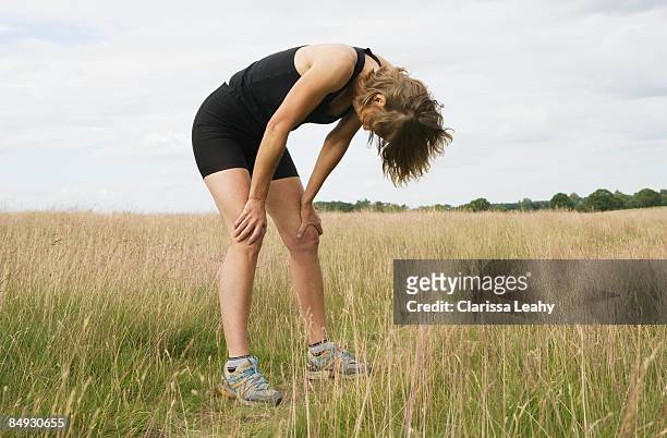 exhausted woman runner resting - tired runner stock pictures, royalty-free photos & images