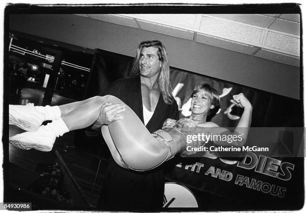 Italian model and actor Fabio picks up an unidentified woman in workout clothing at a party in May 1994 in New York City, New York. Fabio appeared on...