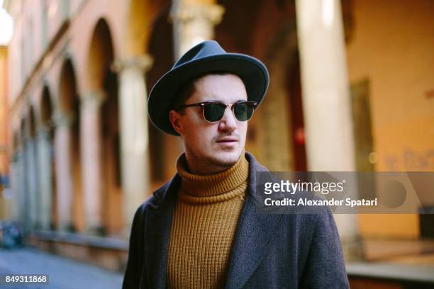 portrait of a young man in hat and sunglasses - orange coat stock pictures, royalty-free photos & images