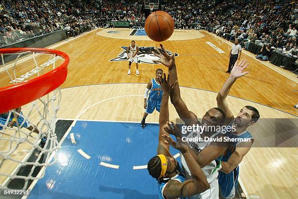 Al Jefferson of the Minnesota Timberwolves shoots against Melvin Ely and Peja Stojakovic of the New Orleans Hornets during the game on January 23,...