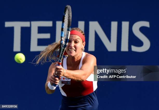 Dominika Cibulkova of Slovakia hits a return against Carla Suarez Navarro of Spain during their women's singles first round match at the Pan Pacific...