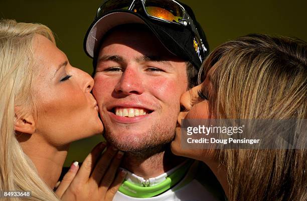 Mark Cavendish of Great Britain and riding for Columbia-Highroad receives congratulatory kisses after claiming the points leader's jersey with his...