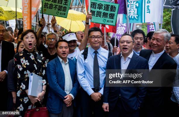 Tanya Chan, Lee Wing-tat, Chan Kin-mam, Benny Tai and Chu Yiu-ming chant slogans in front of the District Court before the trial on public nuisance...