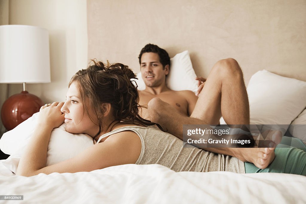 Young couple on bed.