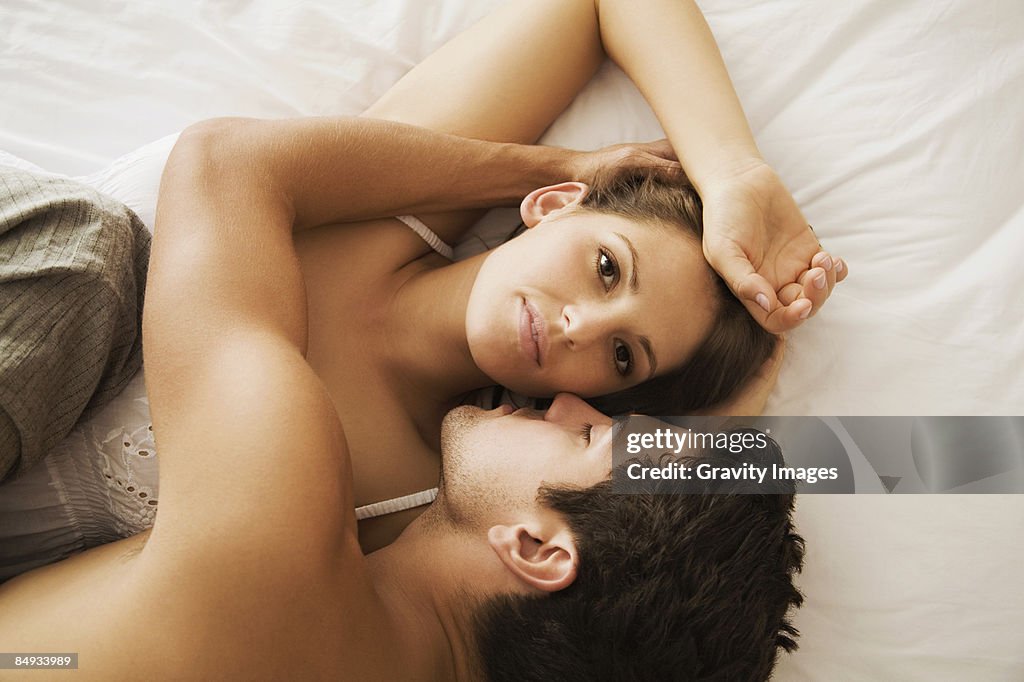 Close-up of couple in bed, view from above