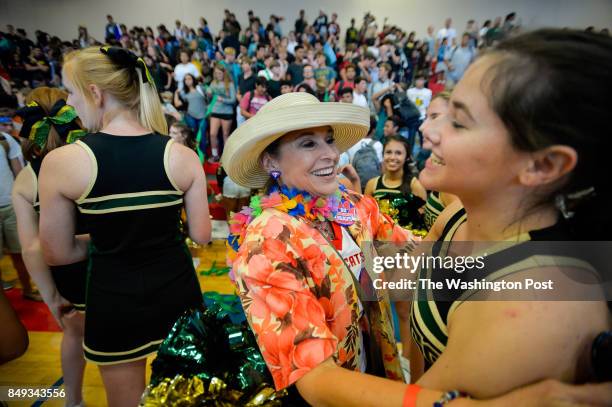 Rockport-Fulton High School cheerleader Lauren Corry, right, gets a hug from Gregory-Portland High School teacher Eleanor Deitz following a joint pep...